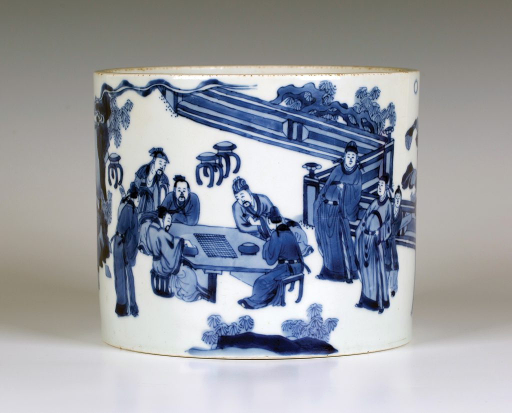 A £30,000 Chinese Kangxi period blue and white porcelain brush pot (bitong), finely painted with a continuous scene of poets and attendants indulging in scholarly pursuits