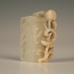1111 A Chinese jade pendant carved as a split trunk of bamboo