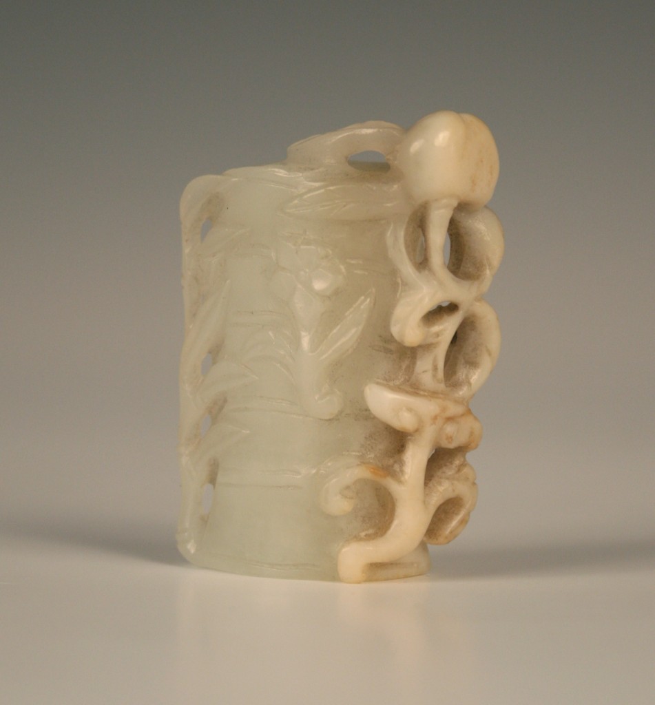 1111 A Chinese jade pendant carved as a split trunk of bamboo