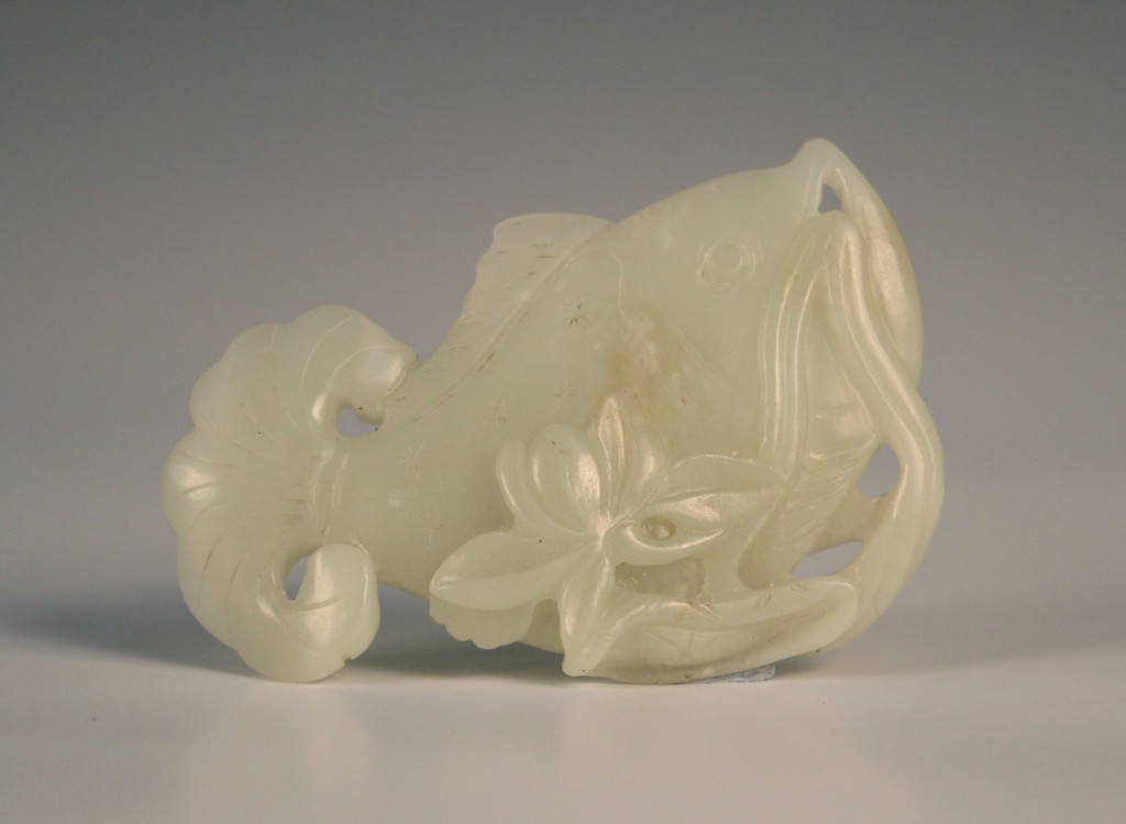 1116 A Chinese pale celadon jade pendant in the form of a fish
