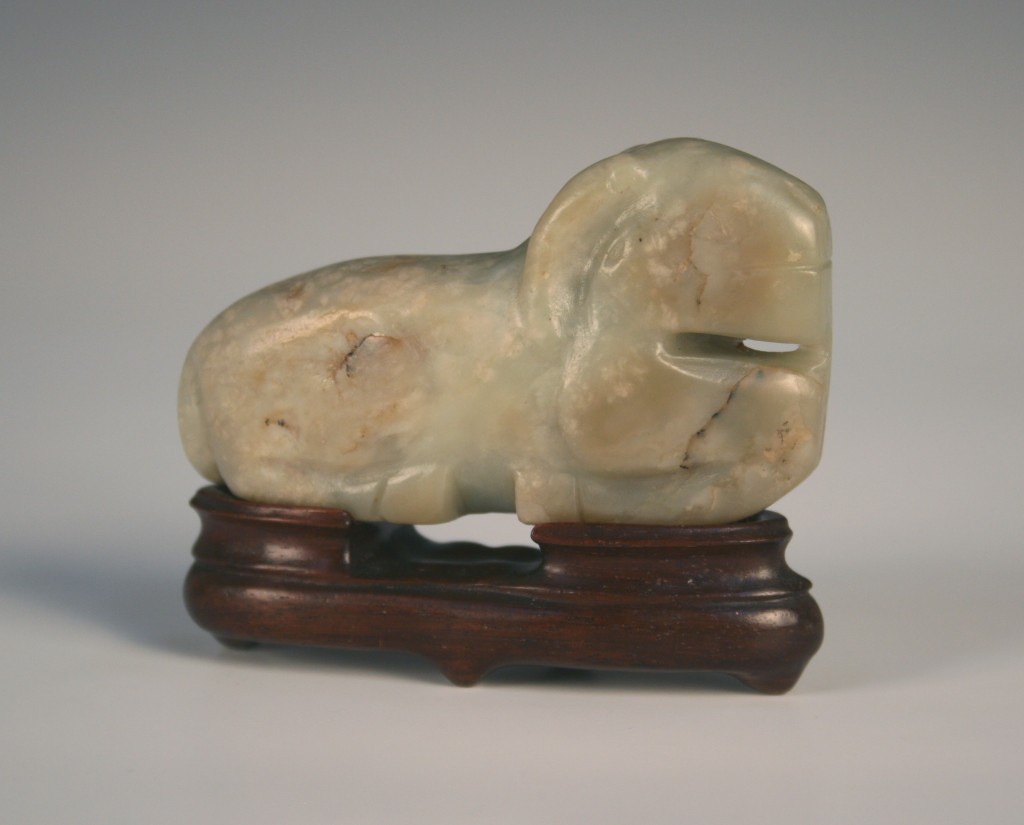 1123 A Chinese celadon jade carving of a recumbent ram