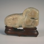 1123 A Chinese celadon jade carving of a recumbent ram