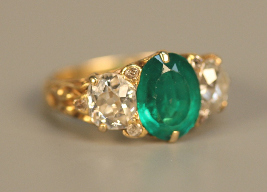 A gold, emerald and diamond ring
