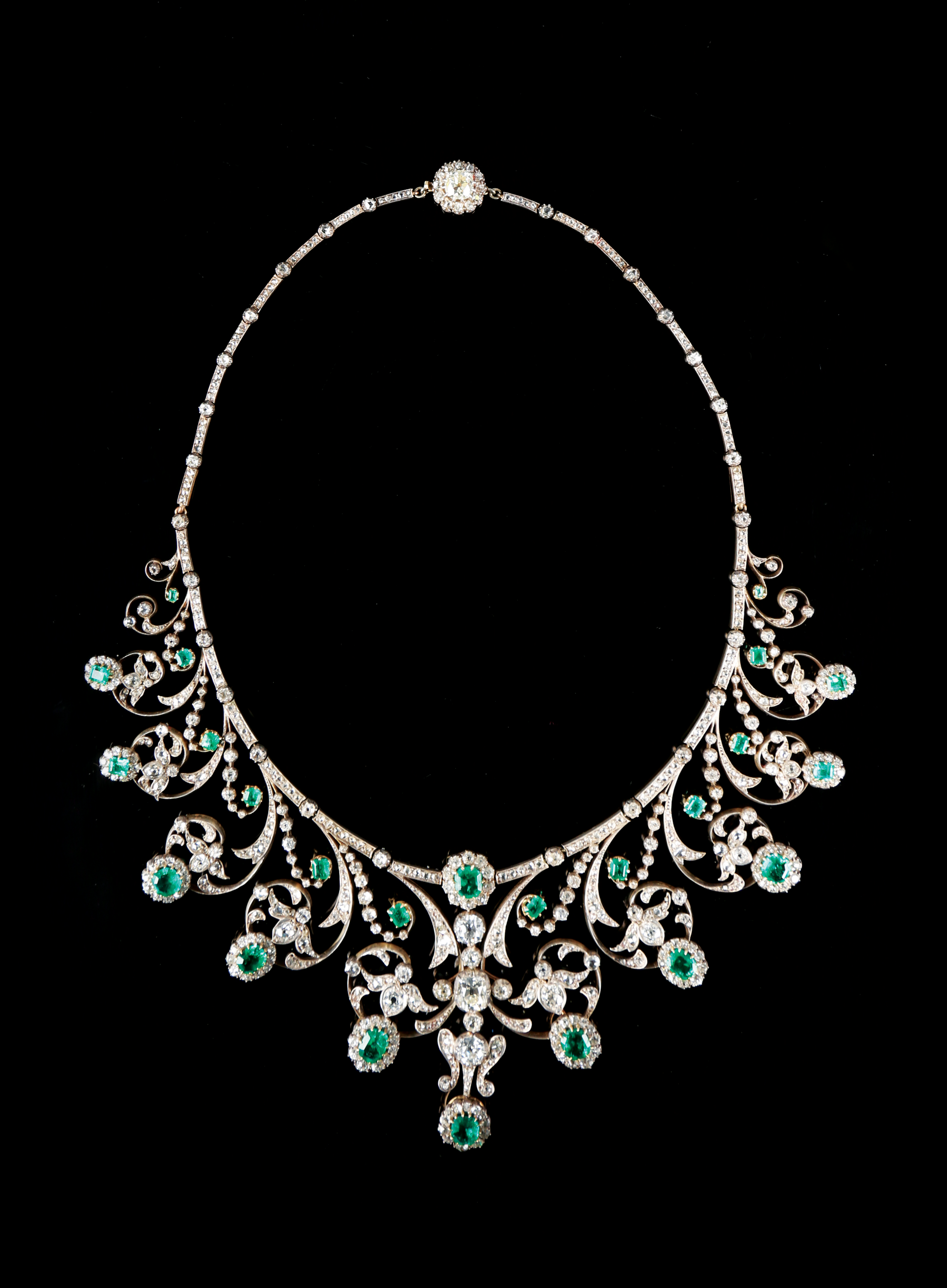 An early 20th century fine emerald and diamond and diamond set necklace in the garland style